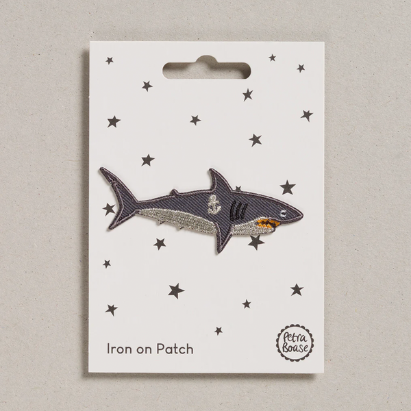 Shark iron on patch on a white card with star patterns, displayed on a light gray background.